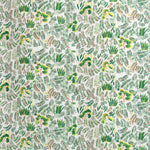 Detail of fabric in a painterly botanical print in shades of green and yellow on a white field.