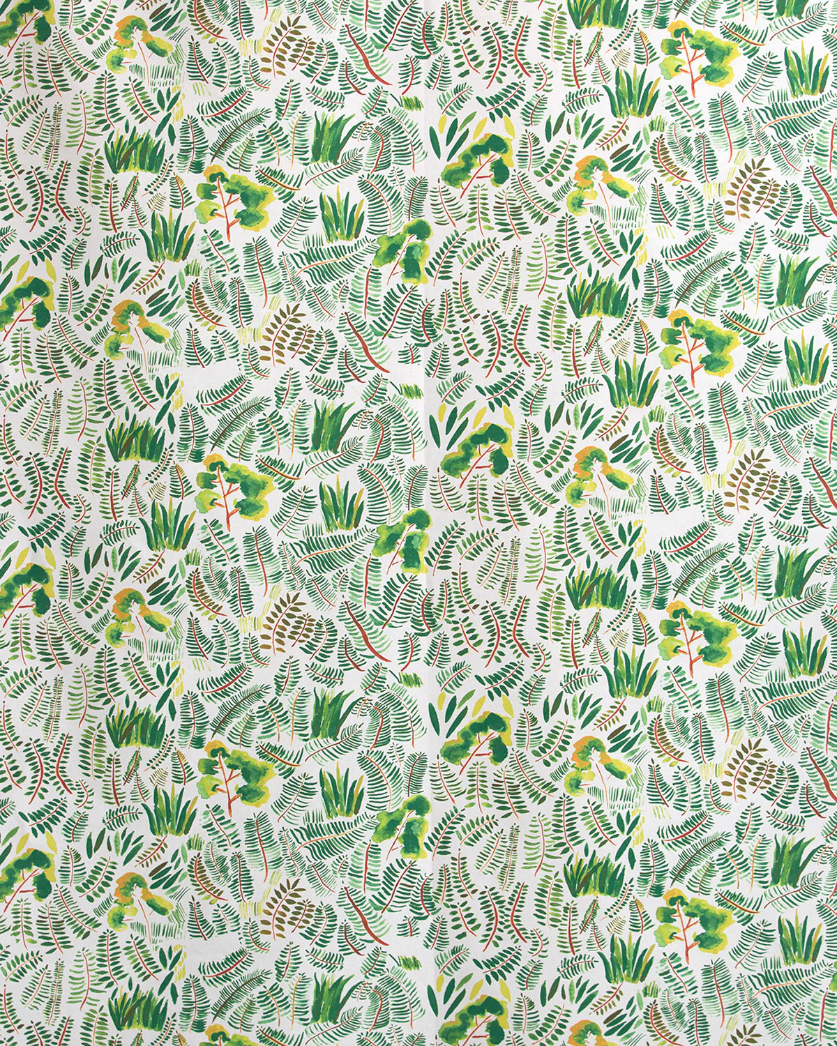 Detail of fabric in a painterly botanical print in shades of green and yellow on a white field.