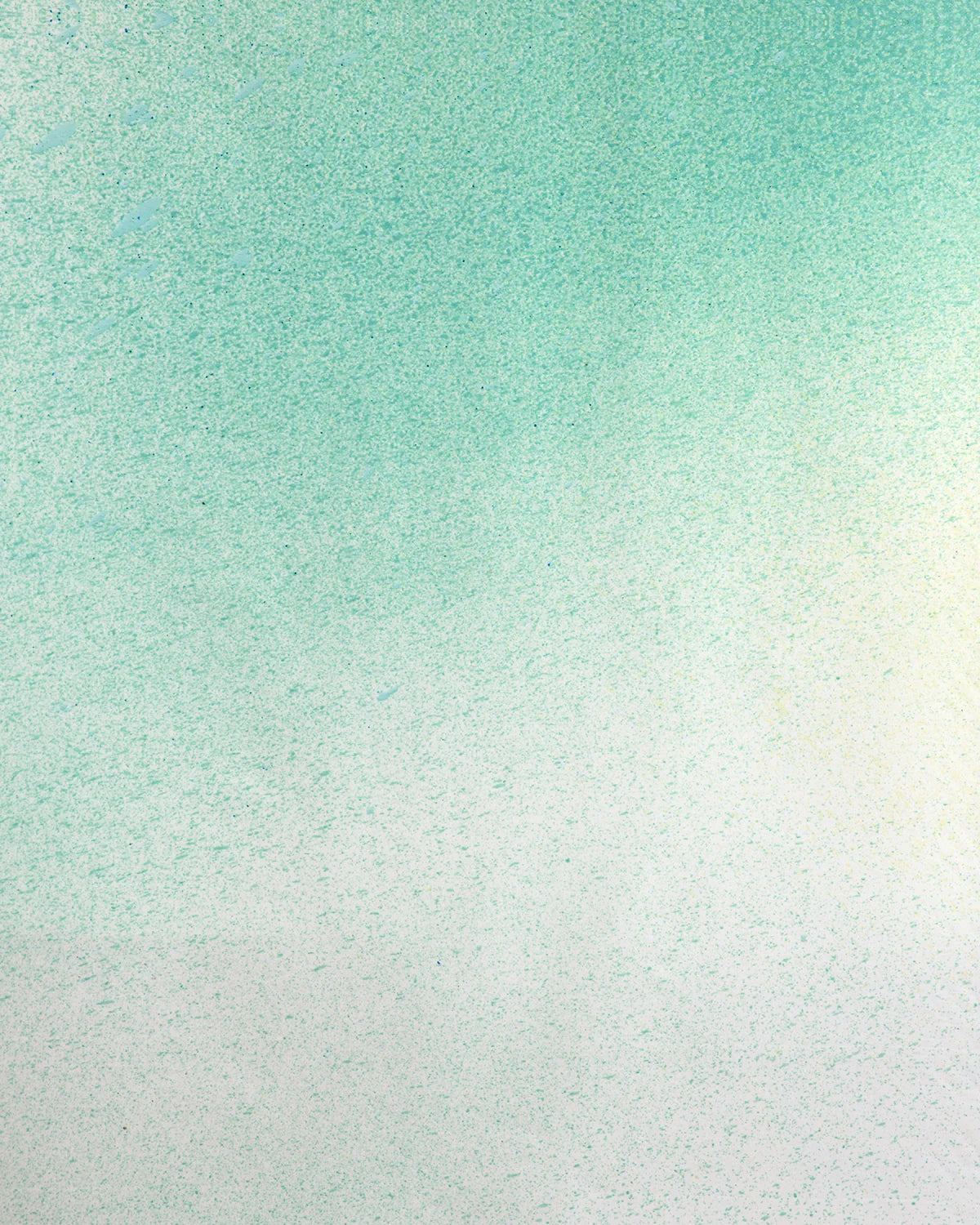 Detail of fabric in an abstract ombré paint splatter print in shades of turquoise, green and white.