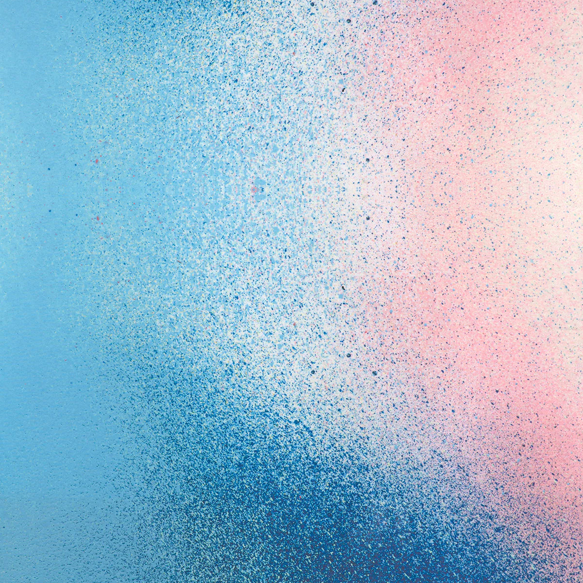 Detail of fabric in an abstract ombré paint splatter print in shades of blue, white, pink and navy.