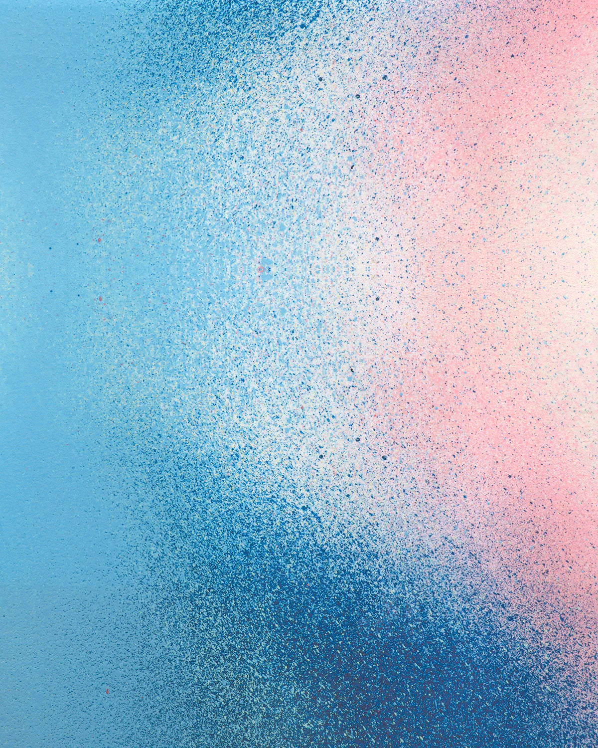 Detail of fabric in an abstract ombré paint splatter print in shades of blue, white, pink and navy.