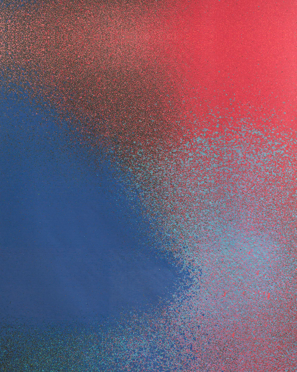 Detail of fabric in an abstract ombré paint splatter print in shades of blue, red and navy.