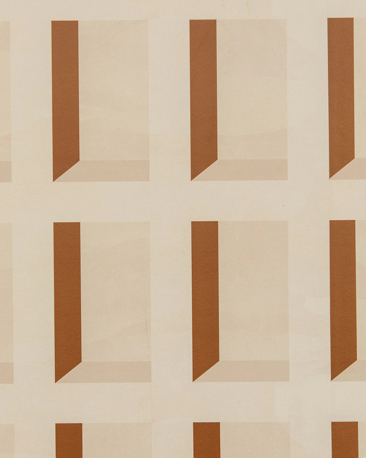 Detail of wallpaper in a dimensional grid print in shades of cream and rust.