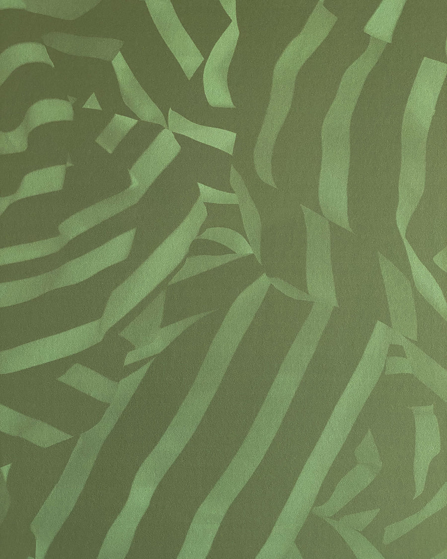 Detail of wallpaper in a playful broken stripe print in dark green on a green field.