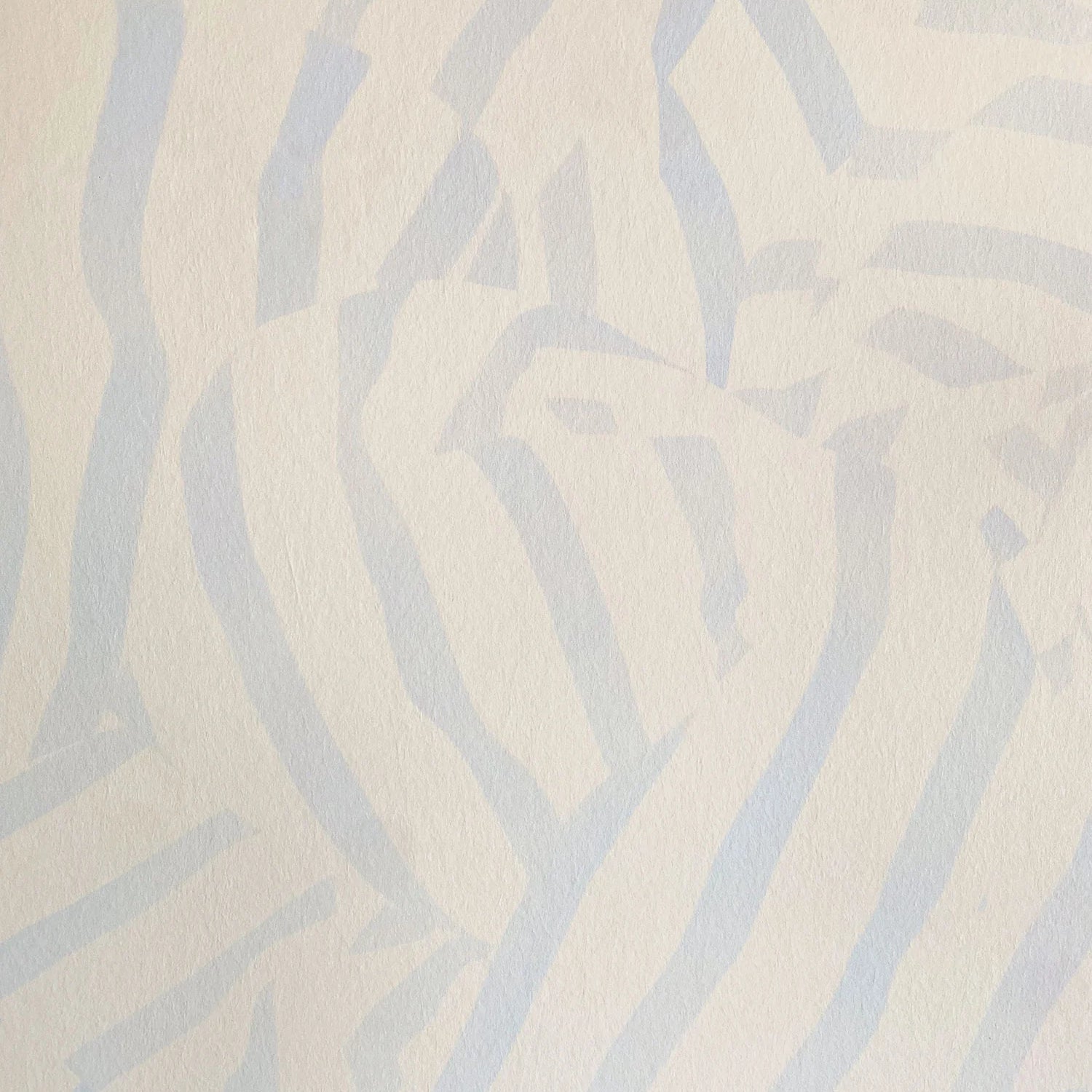 Detail of wallpaper in a playful broken stripe print in light blue on a cream field.