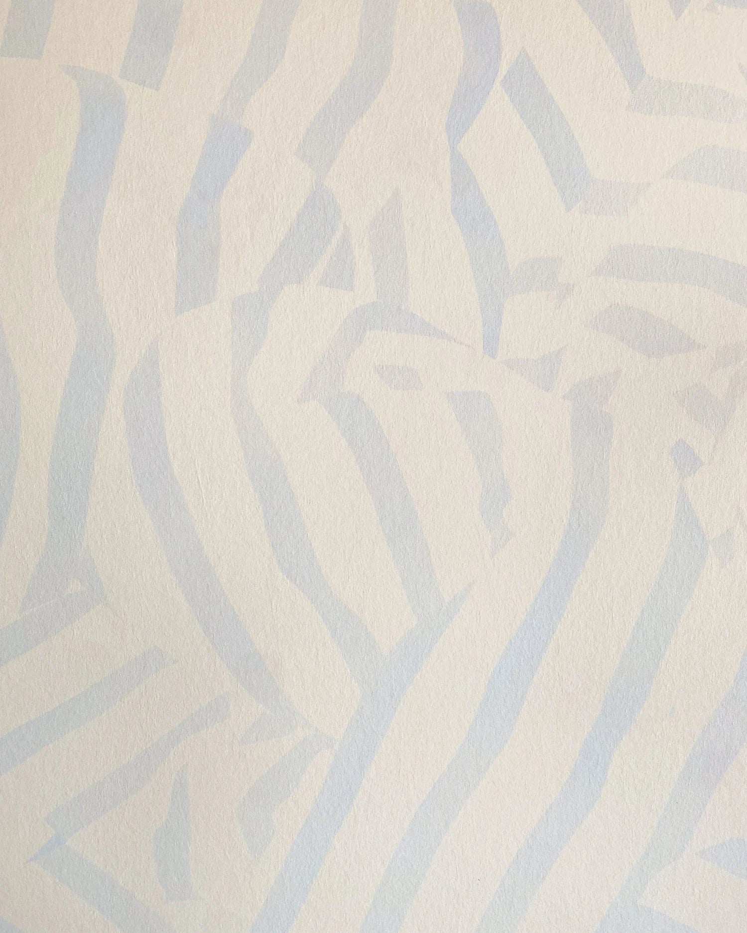 Detail of wallpaper in a playful broken stripe print in light blue on a cream field.