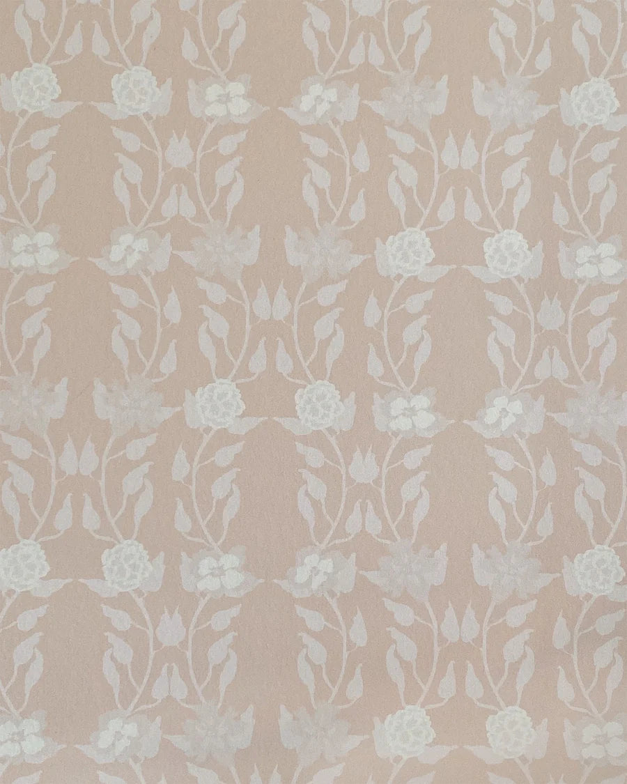 Detail of wallpaper in a linear floral print in white and cream on a light pink field.