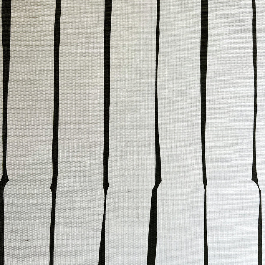 Detail of fabric in a playful irregular stripe print in black on a cream field.