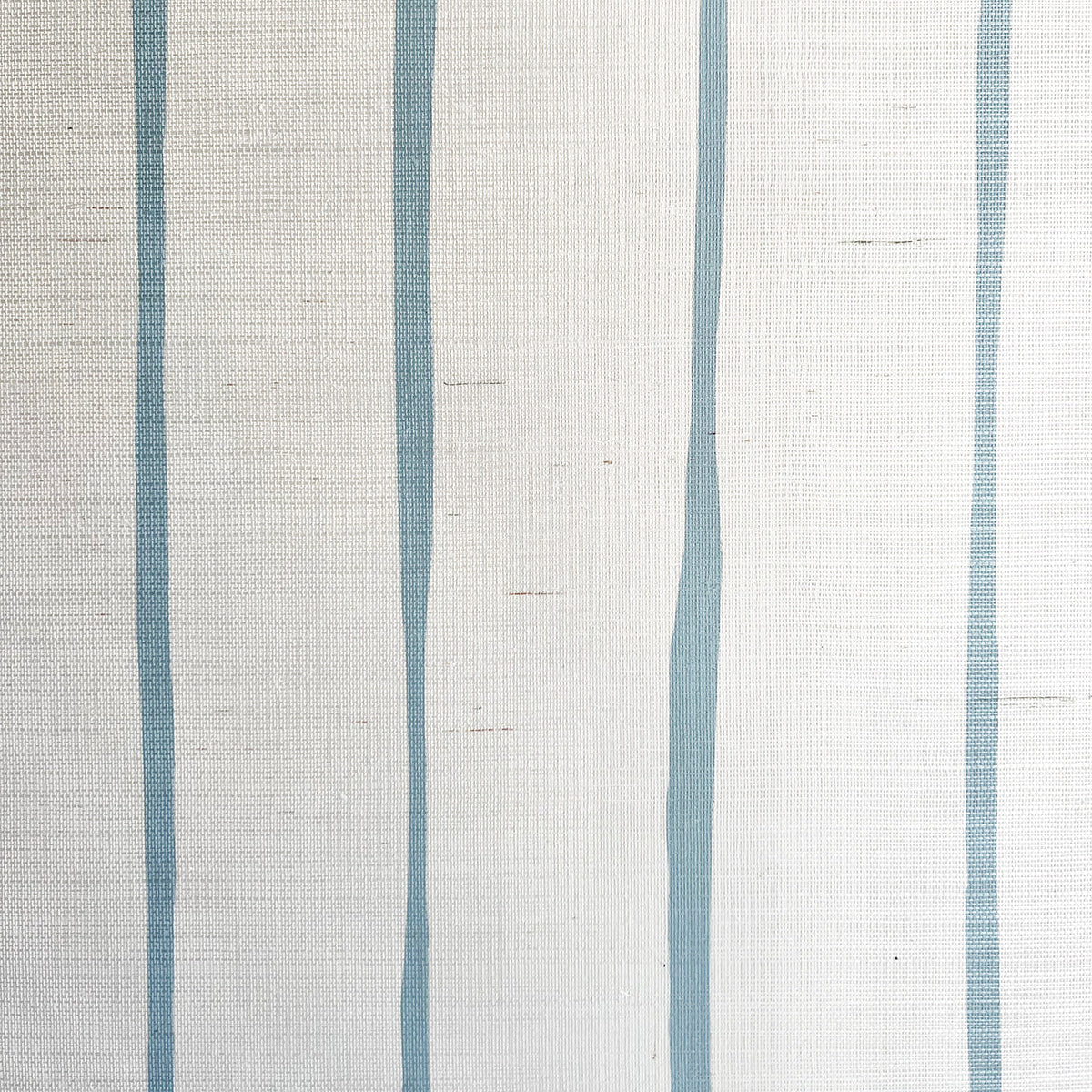 Detail of fabric in a playful irregular stripe print in blue on a cream field.