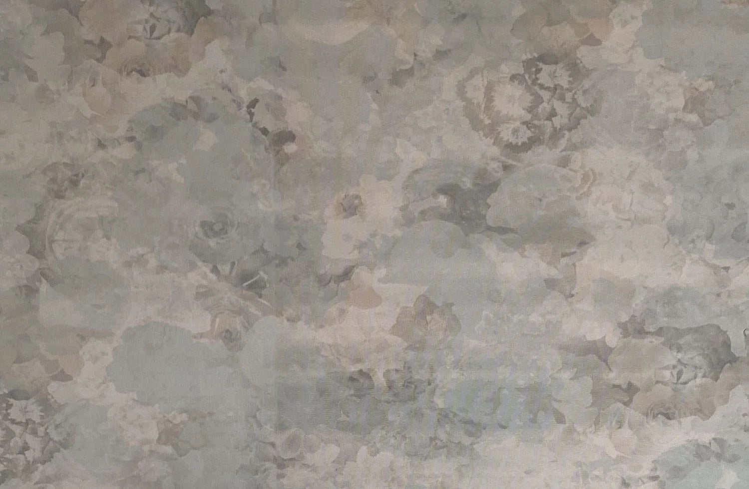 Detail of wallpaper in a dense photorealistic floral print in shades of gray.