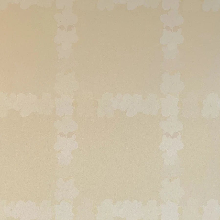 Detail of wallpaper in a floral grid print in cream on a tan field.