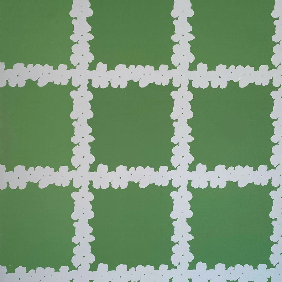 Detail of wallpaper in a floral grid print in white on a green field.