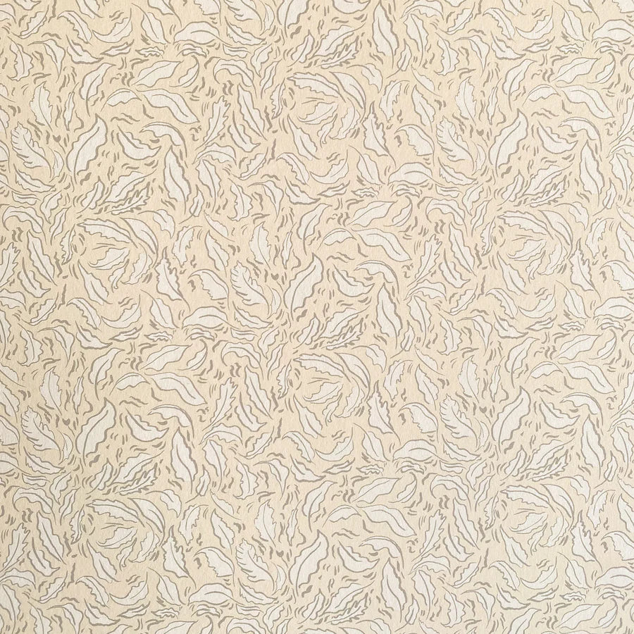 Detail of wallpaper in a painterly leaf print in tan and white on a cream field.