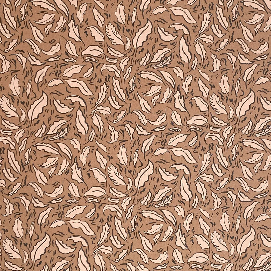 Detail of wallpaper in a painterly leaf print in cream and black on a brown field.