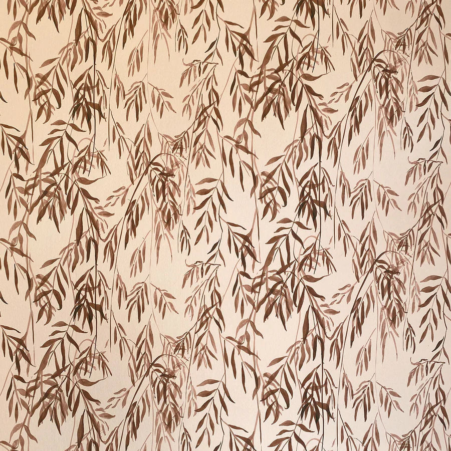 Detail of wallpaper in a painterly willow leaf print in brown on a cream field.