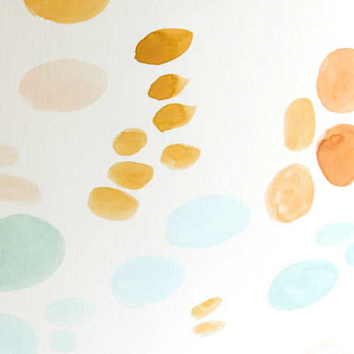 Detail of wallpaper in an abstract painterly print in shades of turquoise, blue and orange on a white field.