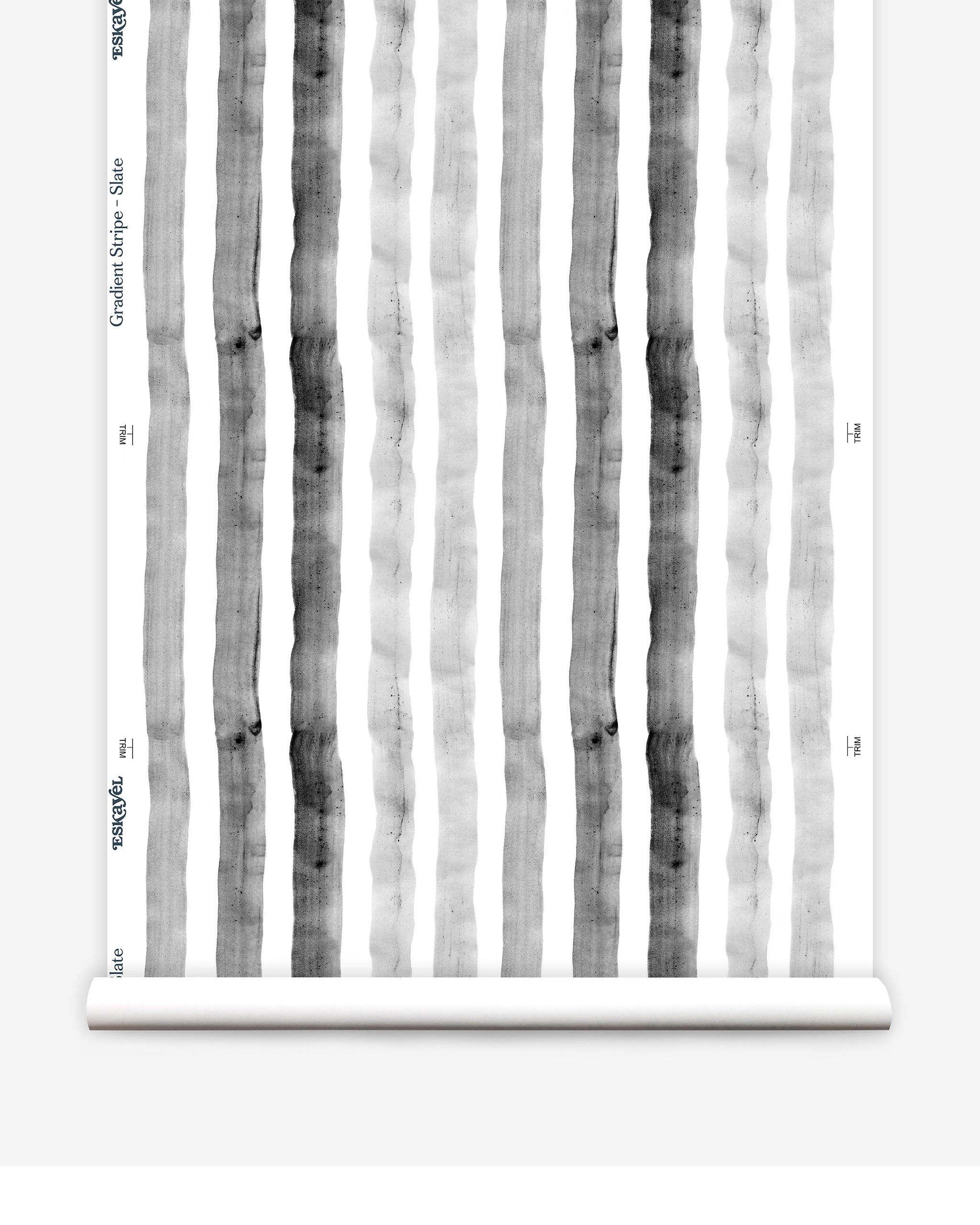 Partially unrolled wallpaper yardage in a painterly stripe print in shades of gray on a white field.