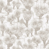 Detail of fabric in a painterly tree print in cream on a white field.