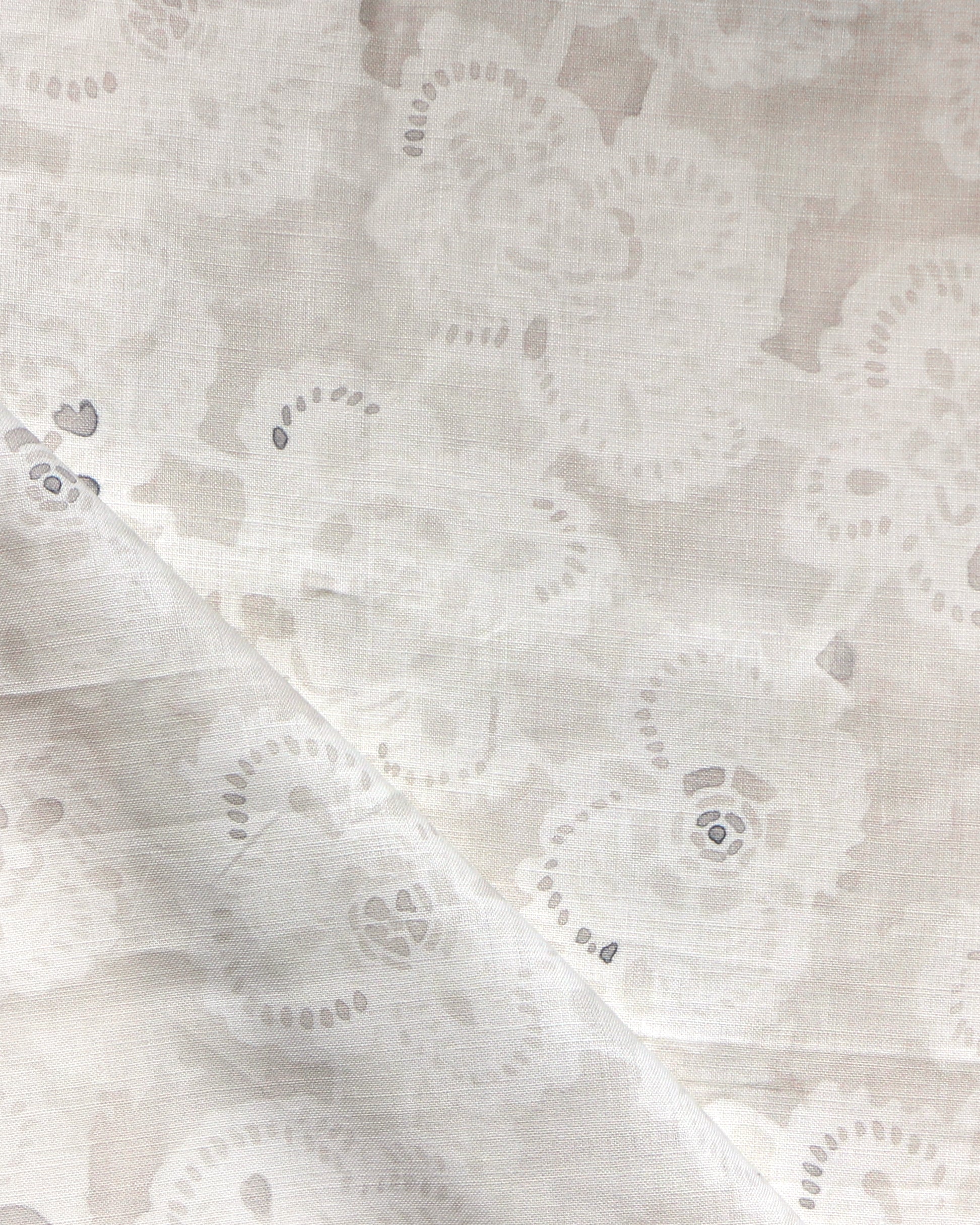 Close-up of a watercolor lace design in soft beige. 