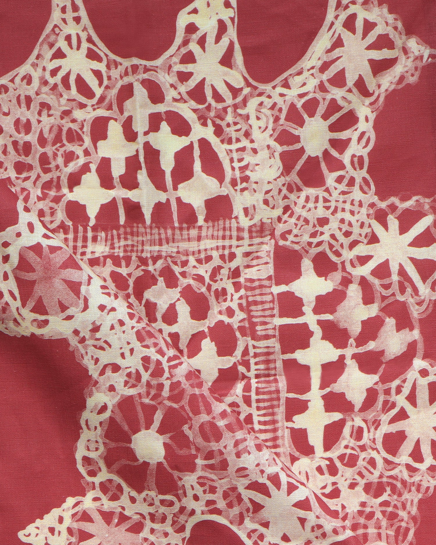 White lace pattern on a red fabric background