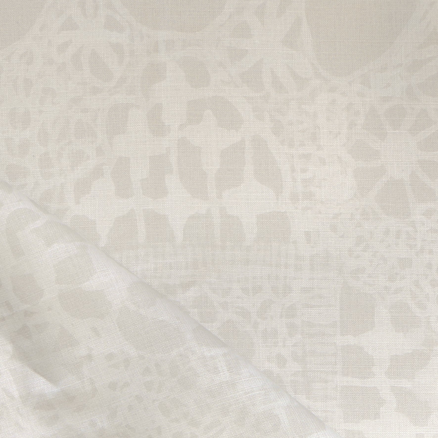 Close-up of a watercolor lace design in soft beige. 