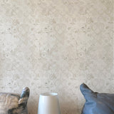 Small white lamp on a surface with a textured wall in the background