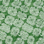 White lace floral pattern on a green background