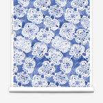 Wallpaper roll with blue watercolor lace floral pattern on a white background.