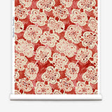 Wallpaper roll with red watercolor lace floral pattern on a white background.