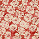 Pattern of white lace flowers on a red background