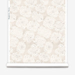 Wallpaper roll with beige watercolor lace floral pattern on a white background.