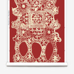 Wallpaper roll with red lace geometric pattern on a white background