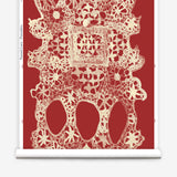 Wallpaper roll with red lace geometric pattern on a white background
