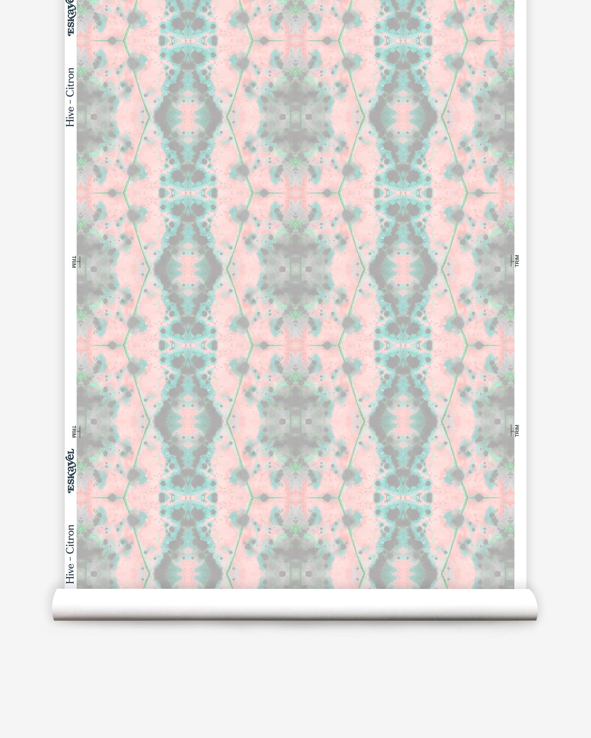 Partially unrolled wallpaper yardage in a painterly gometric stripe in gray, blue and green on a pink field.