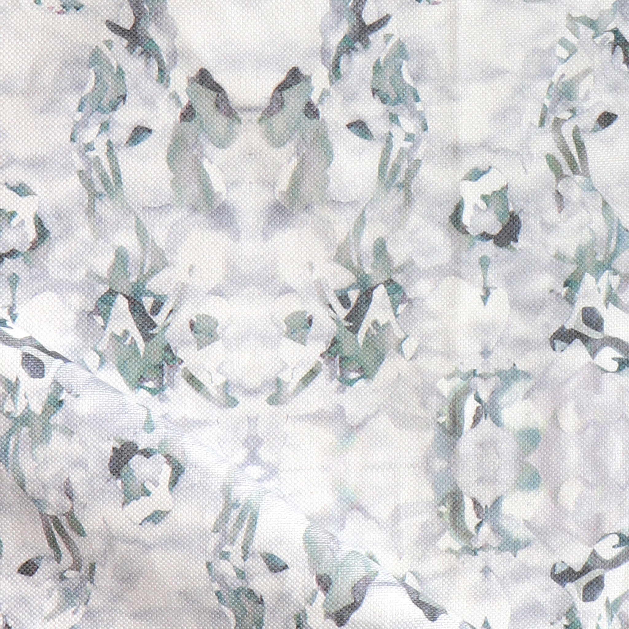 Detail of fabric in an abstract paint blotch print in gray and turquoise on a white field.