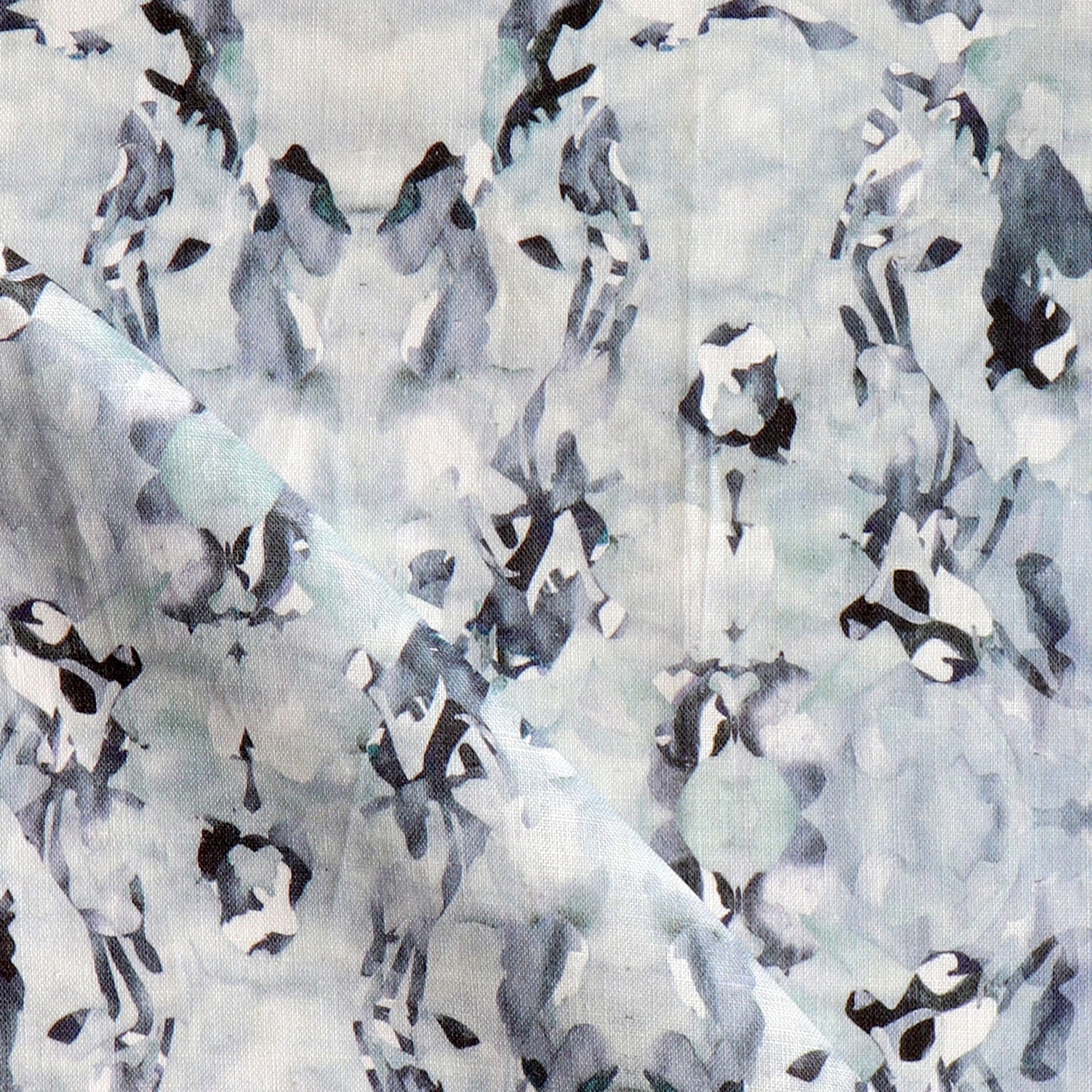 Detail of fabric in an abstract paint blotch print in blue, gray and purple on a white field.