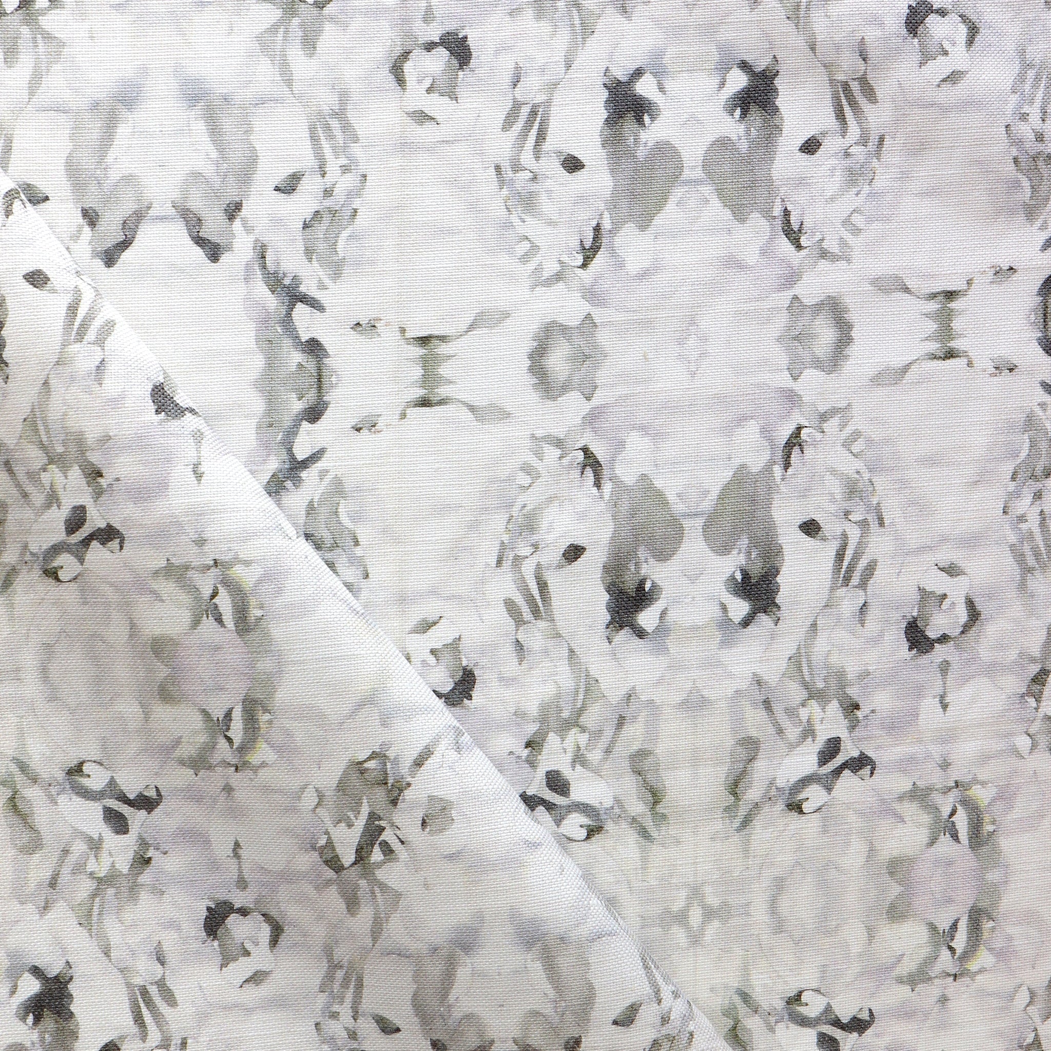 Detail of fabric in an abstract paint blotch print in purple and gray on a white field.