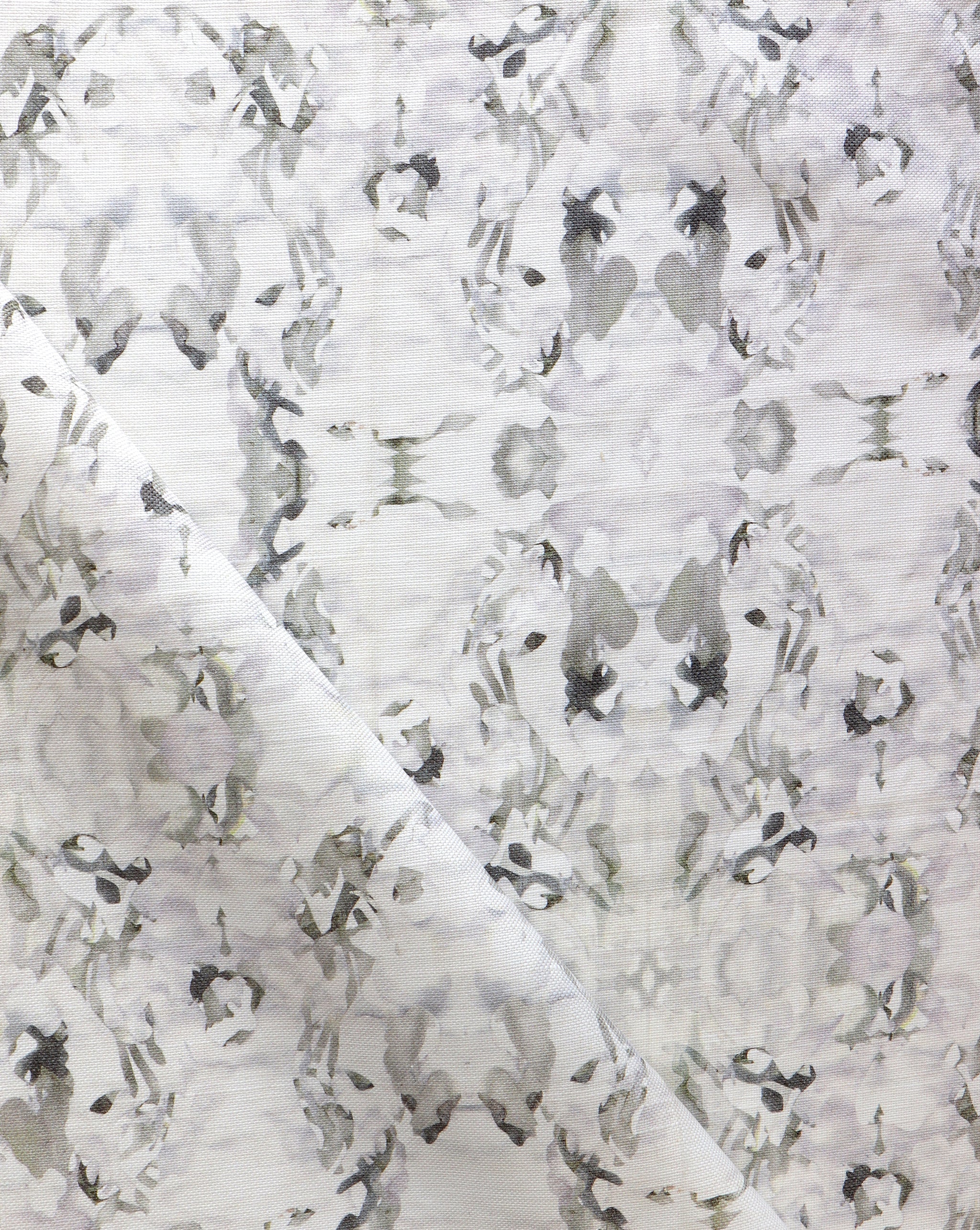 Detail of fabric in an abstract paint blotch print in purple and gray on a white field.