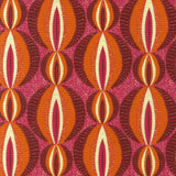 Detail of fabric in an interlocking circular stripe print in shades of pink, orange and purple on a pink field.