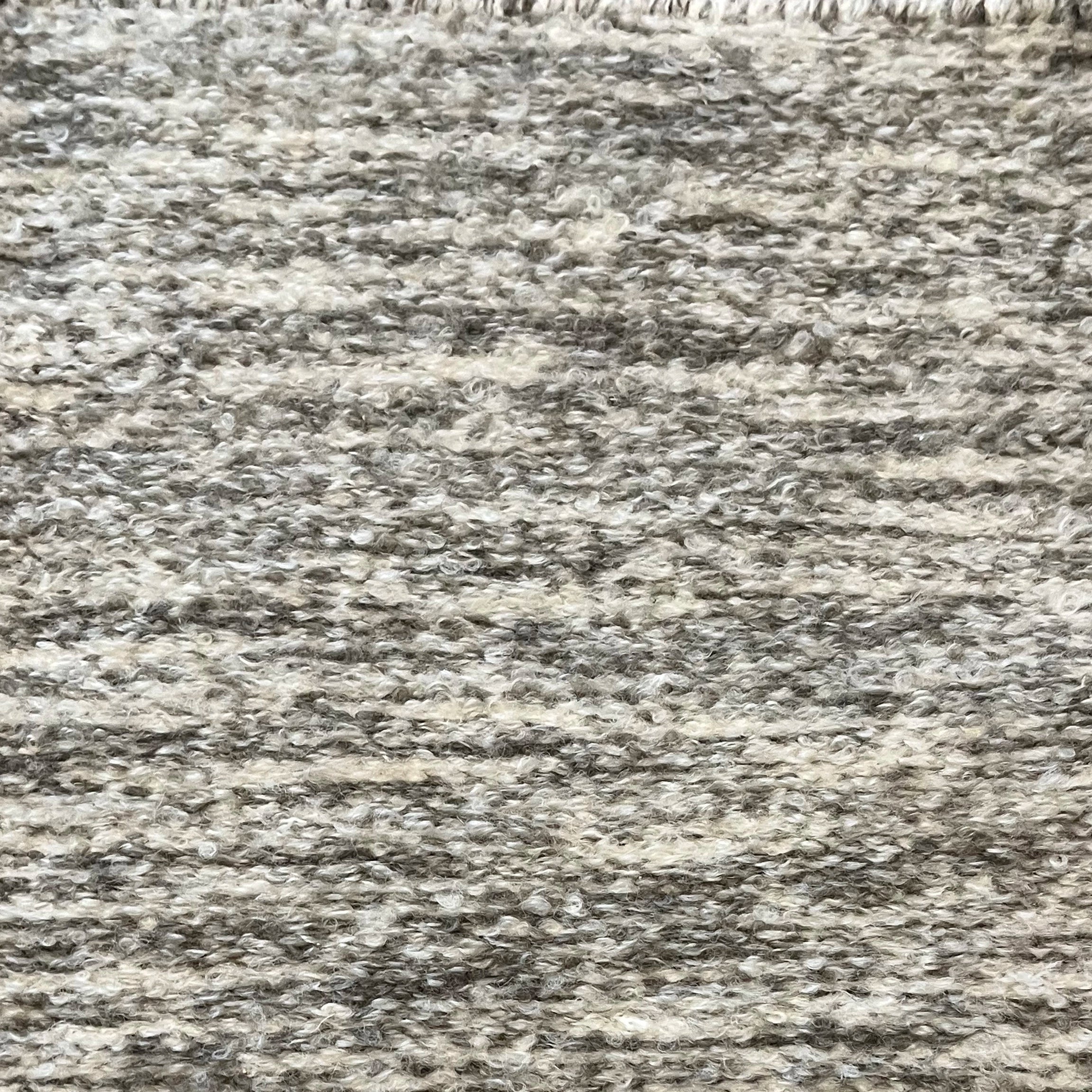 Textural bouclé broadloom carpet in heathered sage and white.