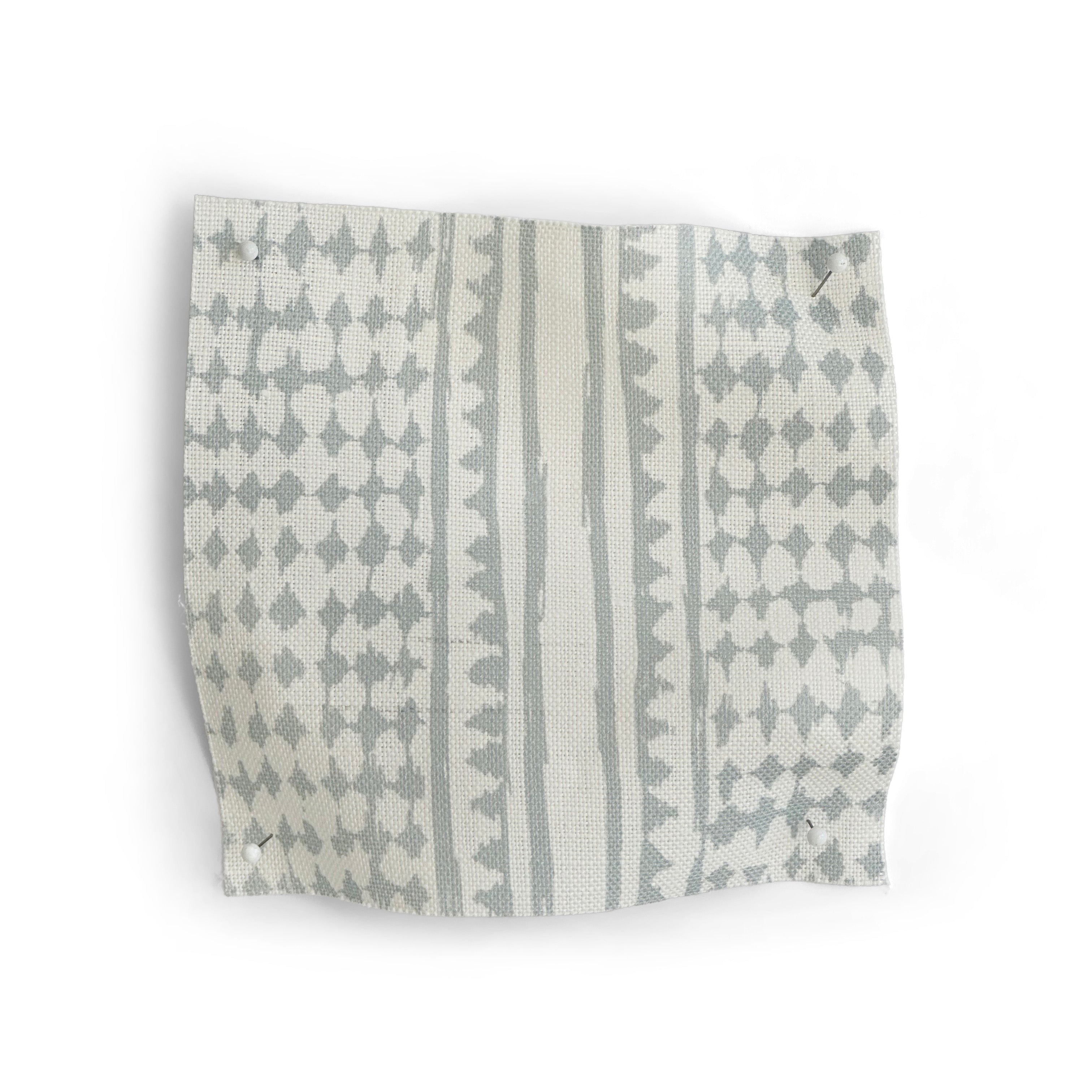Patterned fabric swatch with blue and white geometric design on a white background