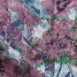 Detail of fabric in a painterly botanical print in purple, green and brown.