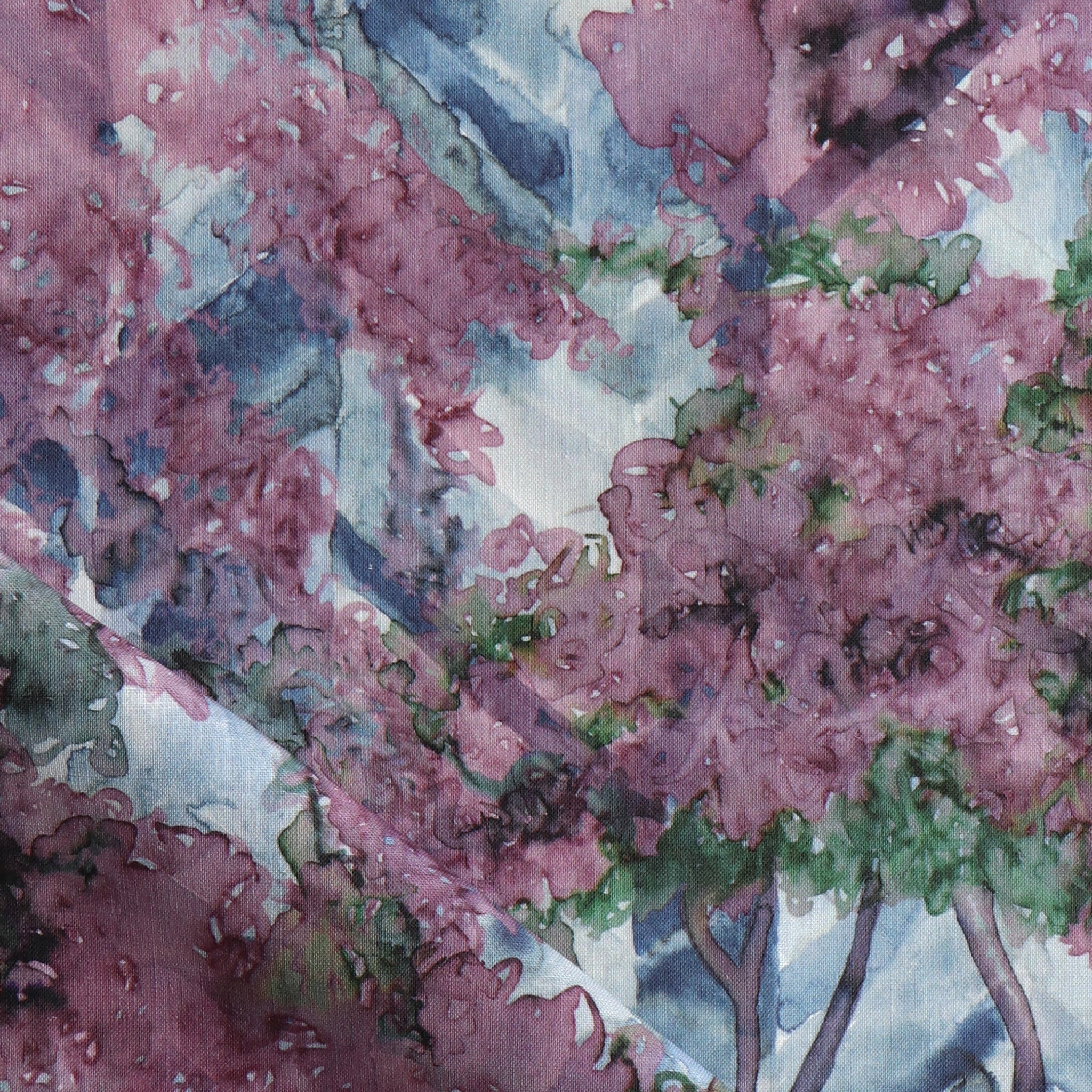 Detail of fabric in a painterly botanical print in purple, green and brown.