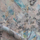 Detail of fabric in a painterly botanical print in cream, gray and turquoise.