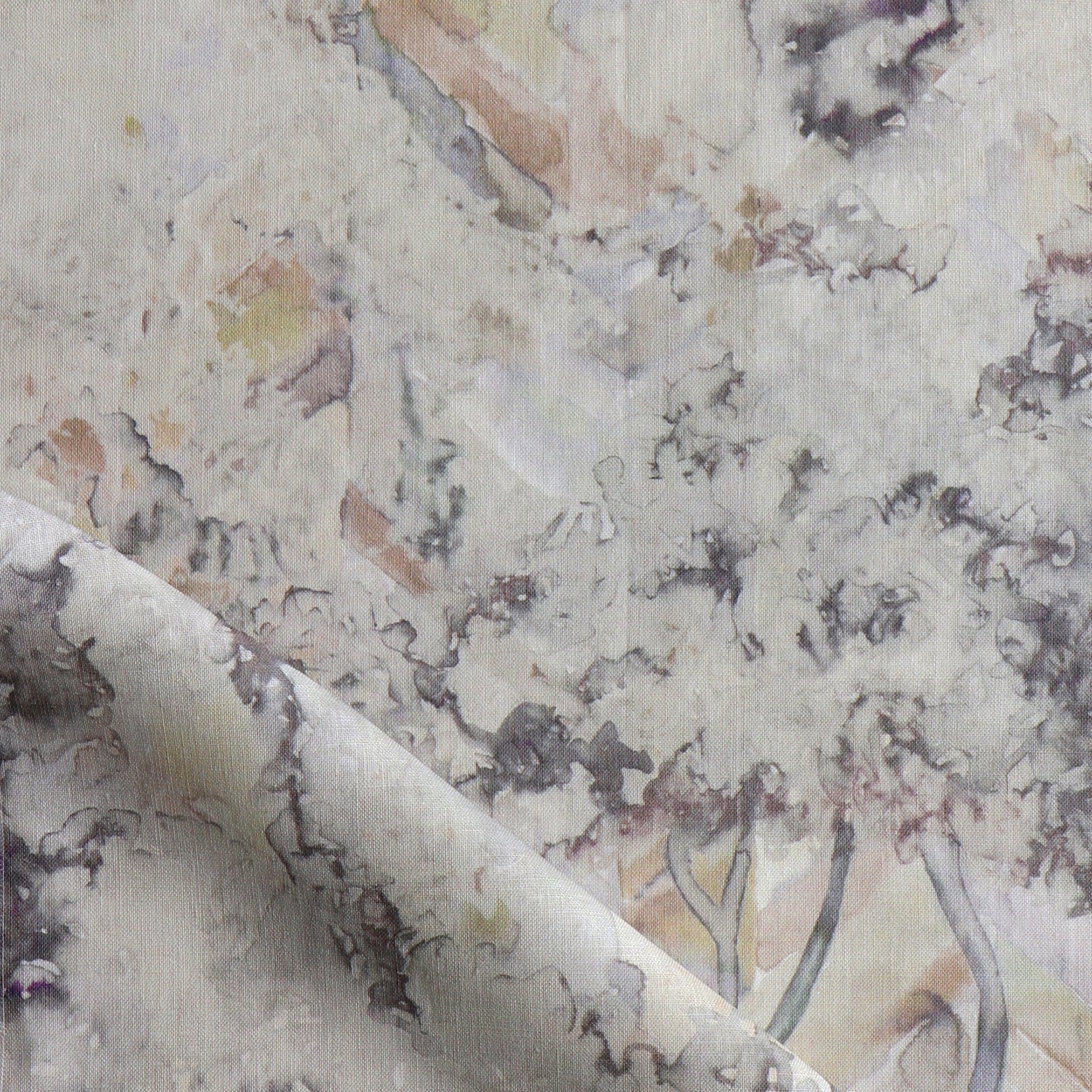 Detail of fabric in a painterly botanical print in gray, brown and purple.