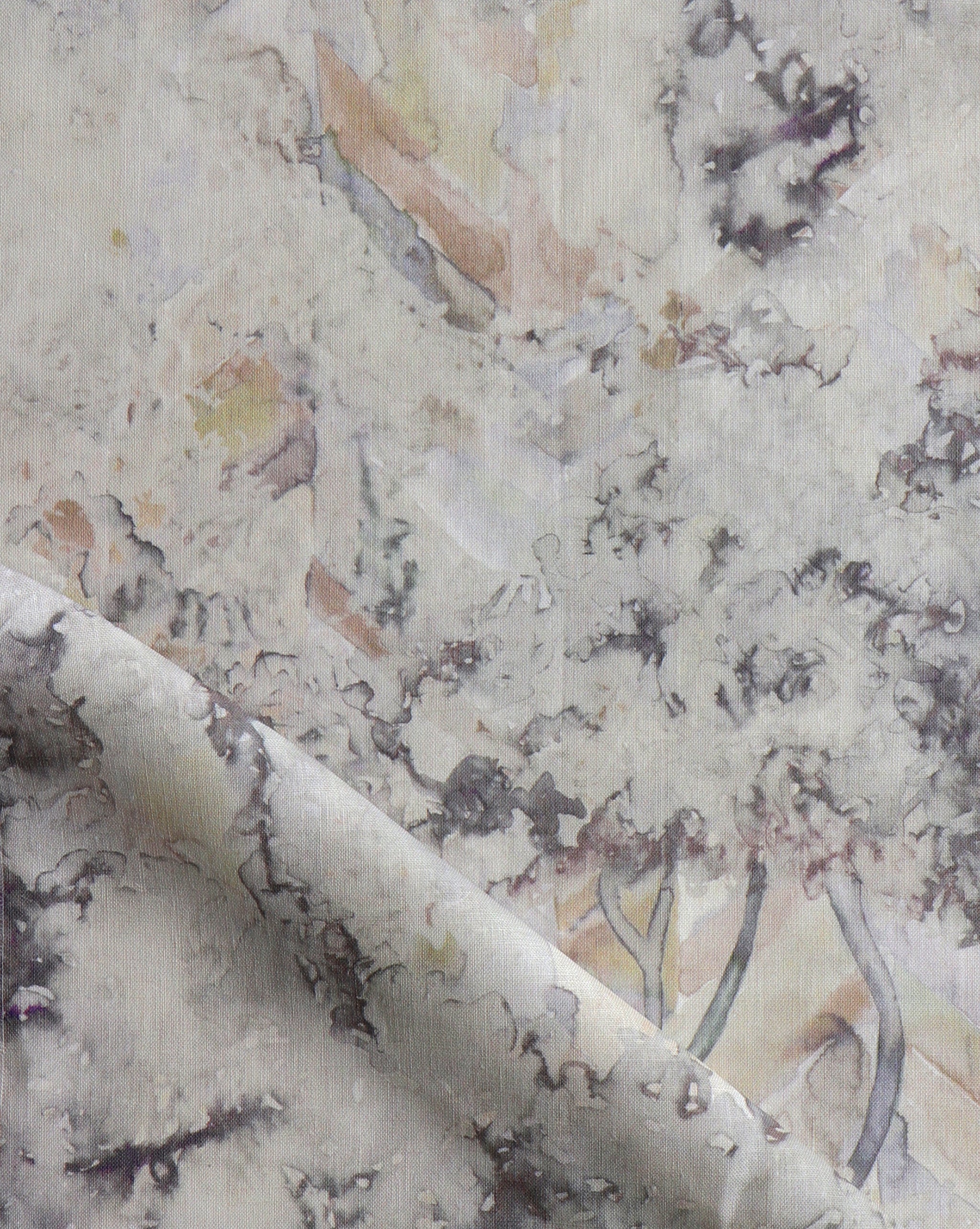 Detail of fabric in a painterly botanical print in gray, brown and purple.