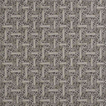 Detail of fabric in a geometric grid pattern in black on a cream field.