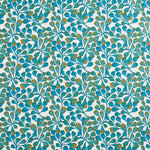 Detail of fabric in an abstract botanical print in blue, turquoise and gold on a white field.