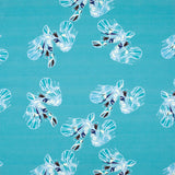 Detail of fabric in a playful feather print in blue and navy on a turquoise field.