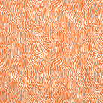 Detail of fabric in a playful animal print in orange on a white field.